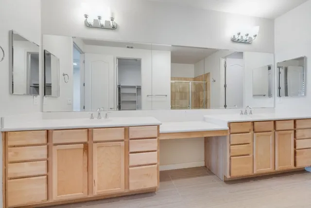 a bathroom with a sink vanity and mirror
