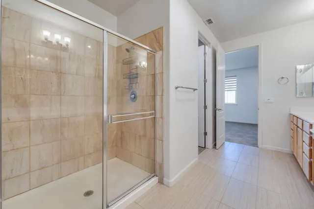 a bathroom with a glass shower door