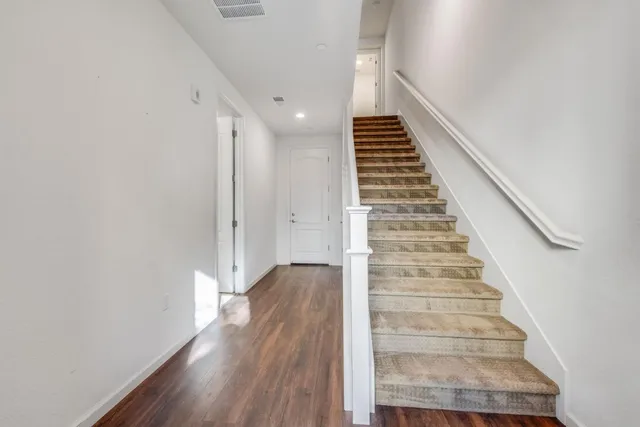 a view of entryway and hall with wooden floor