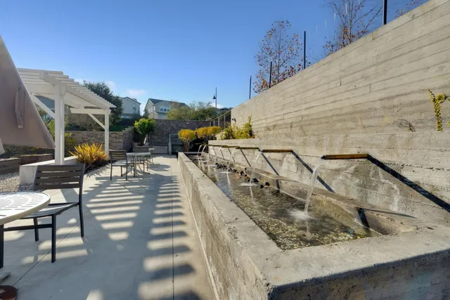 a view of a backyard with sitting area