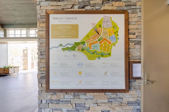 a view of a lake with a yard and potted plants