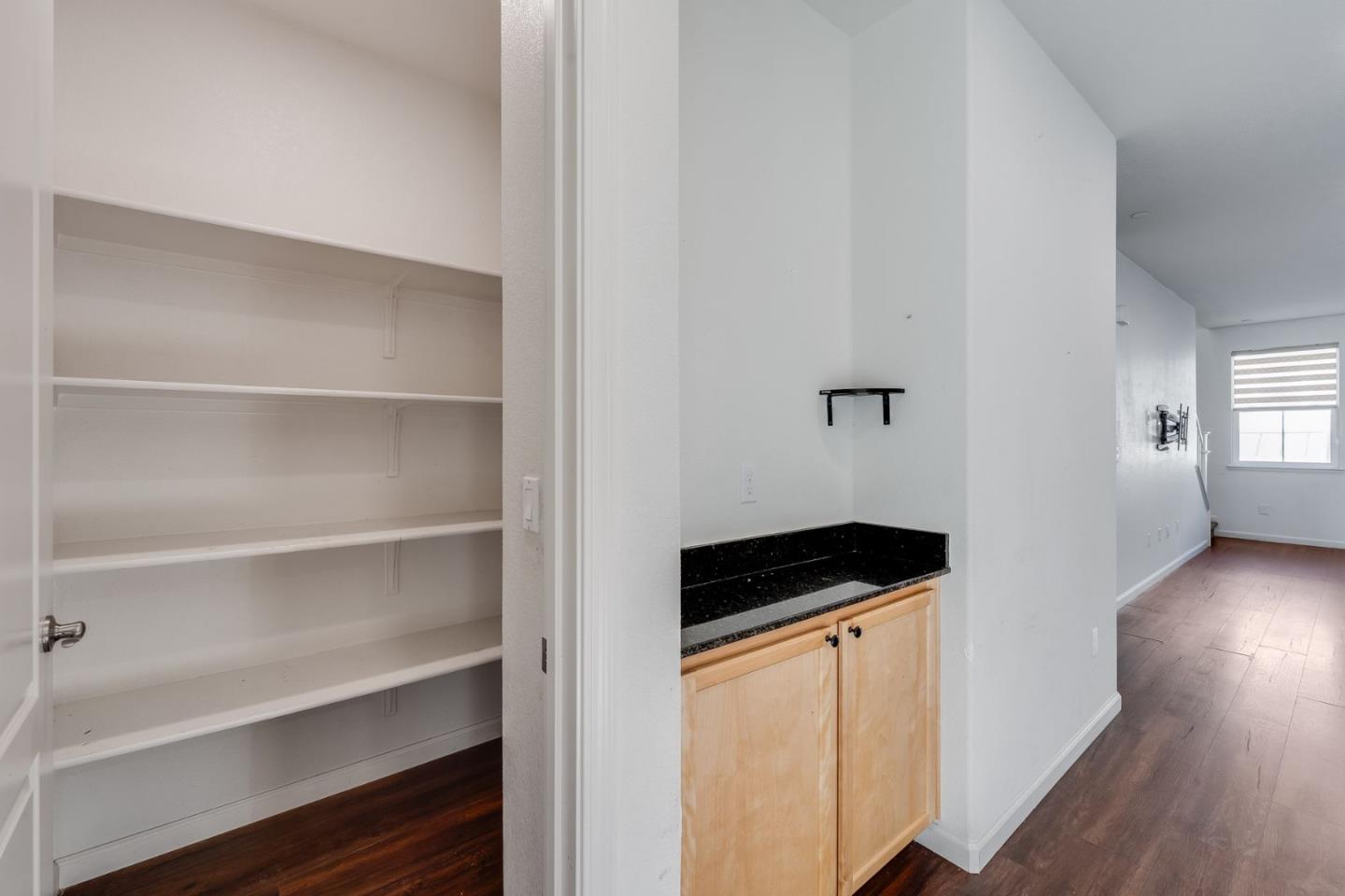 6914 Geyserville Street Dublin, CA 94568 - Photo 10 of 43 a kitchen with a refrigerator and cabinets