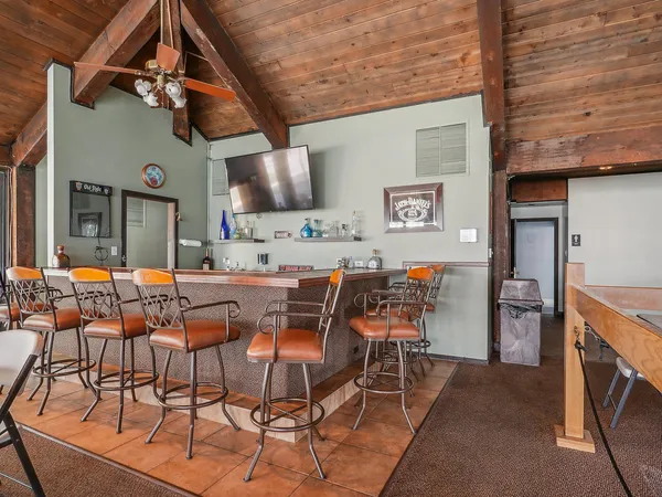 a outdoor space with lots of tables a large window and chairs