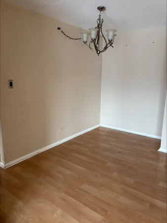 a view of a room with wooden floor and white walls
