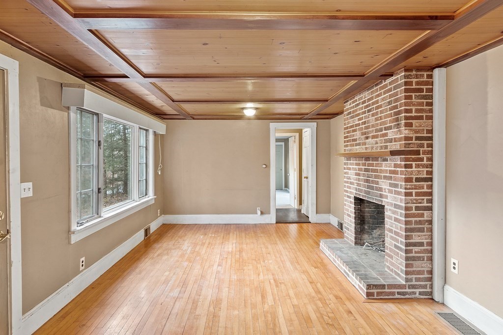 146 Riceville Road Athol, MA 01331 - Photo 11 of 42 a view of empty room with wooden floor and fireplace