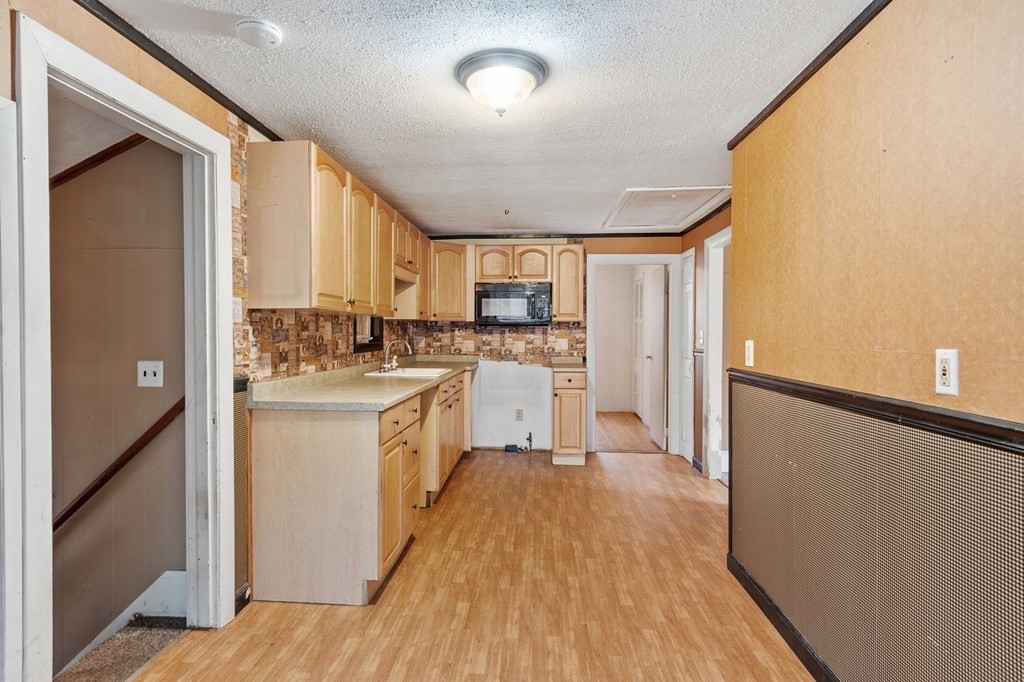 146 Riceville Road Athol, MA 01331 - Photo 6 of 42 a kitchen with a refrigerator a sink and wooden floor