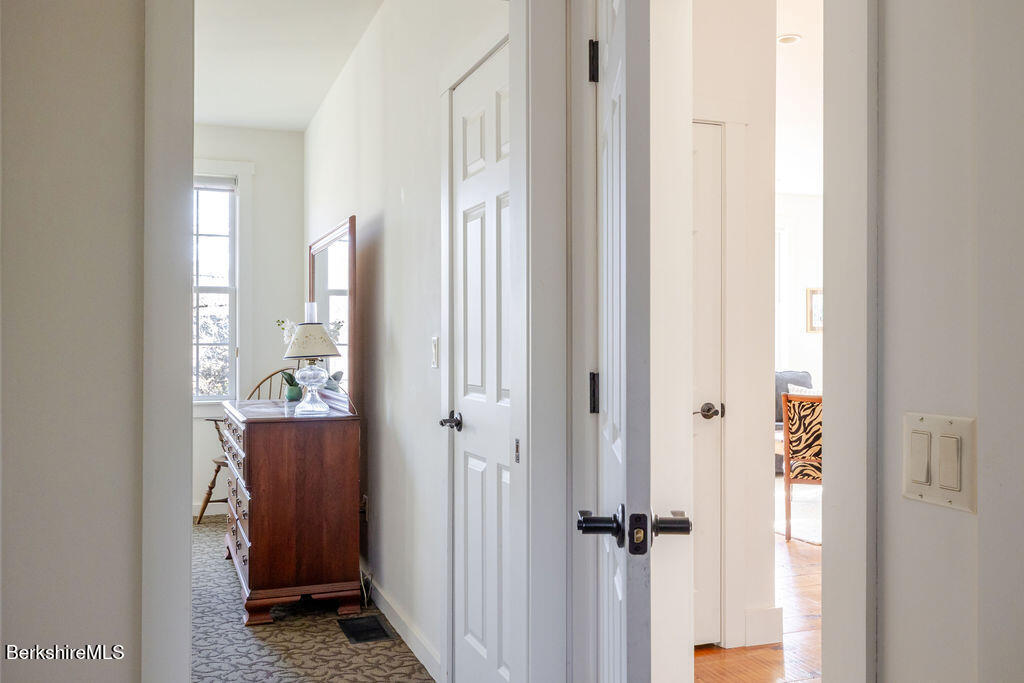 165 D Maple Avenue Great Barrington, MA 01230 - Photo 17 of 32 a view of a hallway with wooden floor and closet