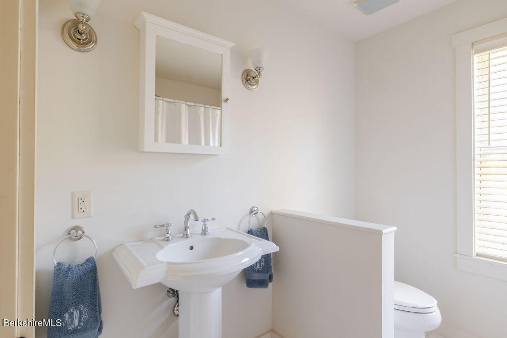 165 D Maple Avenue Great Barrington, MA 01230 - Photo 25 of 32 a bathroom with a sink a toilet and a window