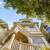 a view of a tall building with large trees