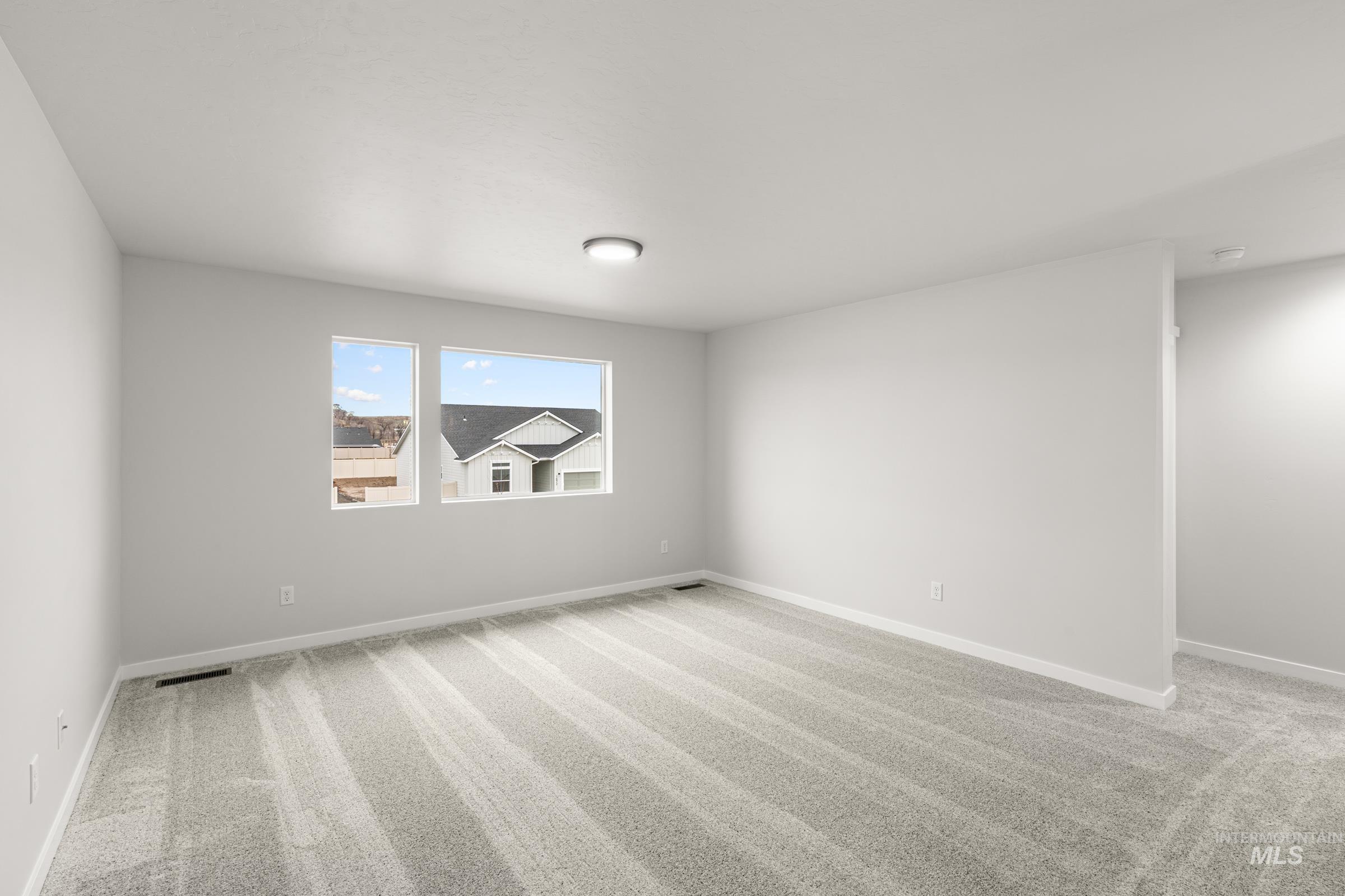 13693 Redway Court Caldwell, ID 83607 - Photo 13 of 25 Spare room featuring light carpet and baseboards