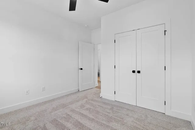 a view of small space with wooden floor and a window
