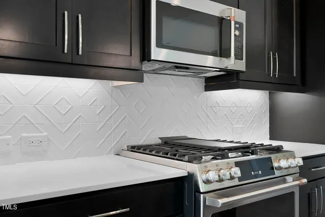 a stove top oven sitting inside of a kitchen
