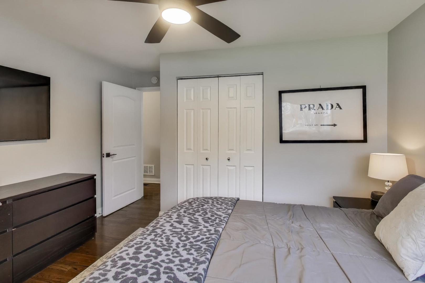 591 South Park Road Lombard, IL 60148 - Photo 12 of 30 a bedroom with a bed and a flat screen tv