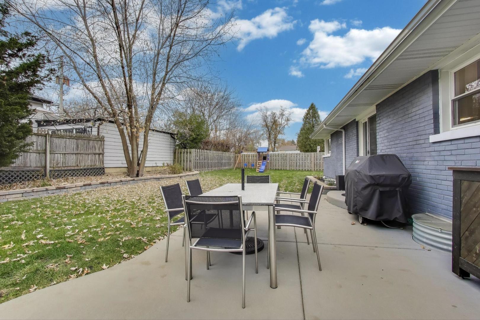 591 South Park Road Lombard, IL 60148 - Photo 30 of 30 a view of backyard with table and chairs and a large tree