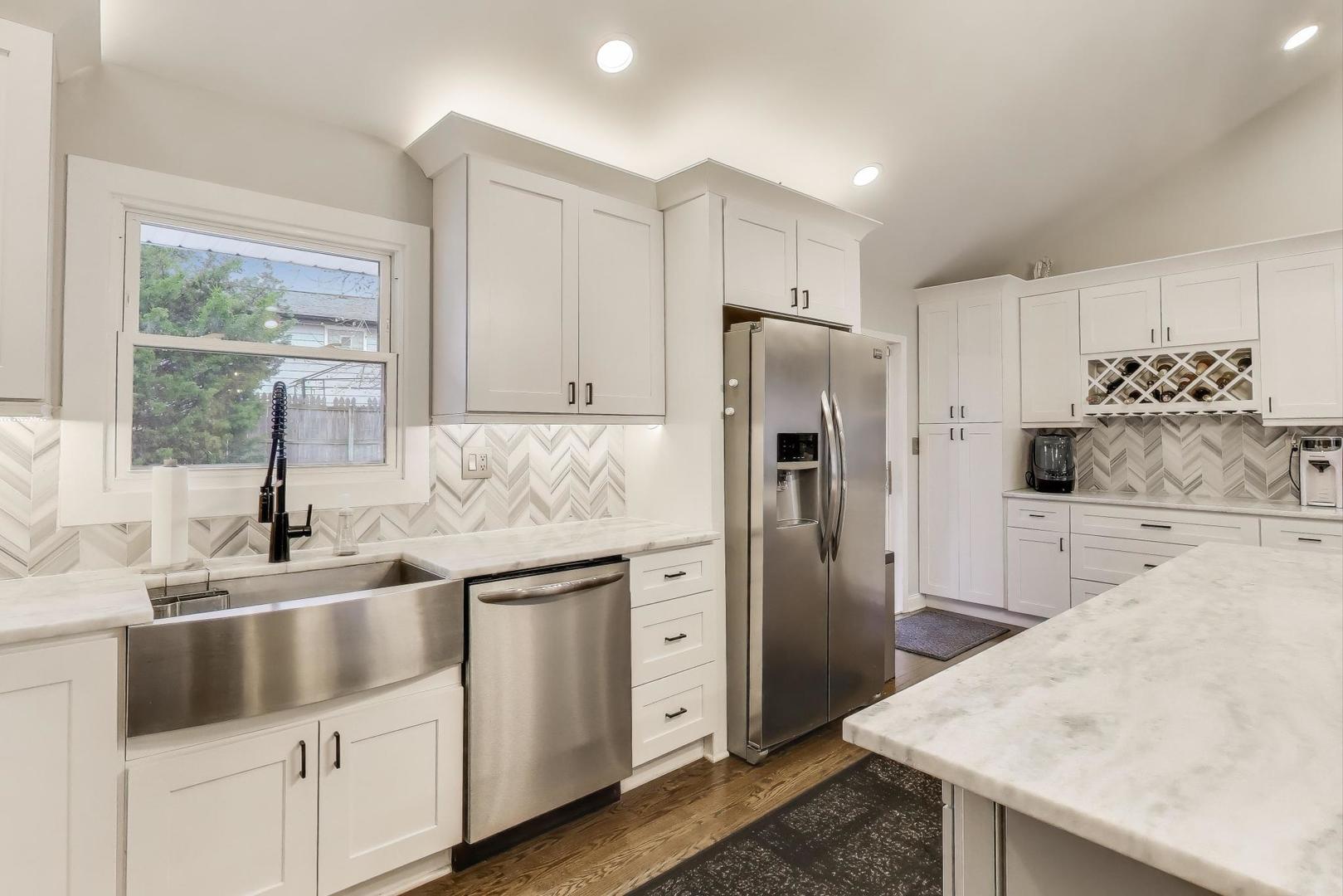 591 South Park Road Lombard, IL 60148 - Photo 6 of 30 a kitchen with white cabinets and stainless steel appliances