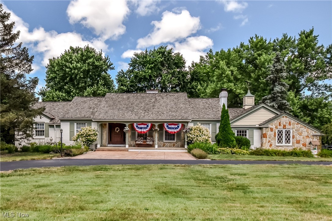 9715 Johnnycake Ridge Road Mentor, OH 44060 - Photo 1 of 50 Ranch-style house featuring a front lawn, a chimney, and stone siding