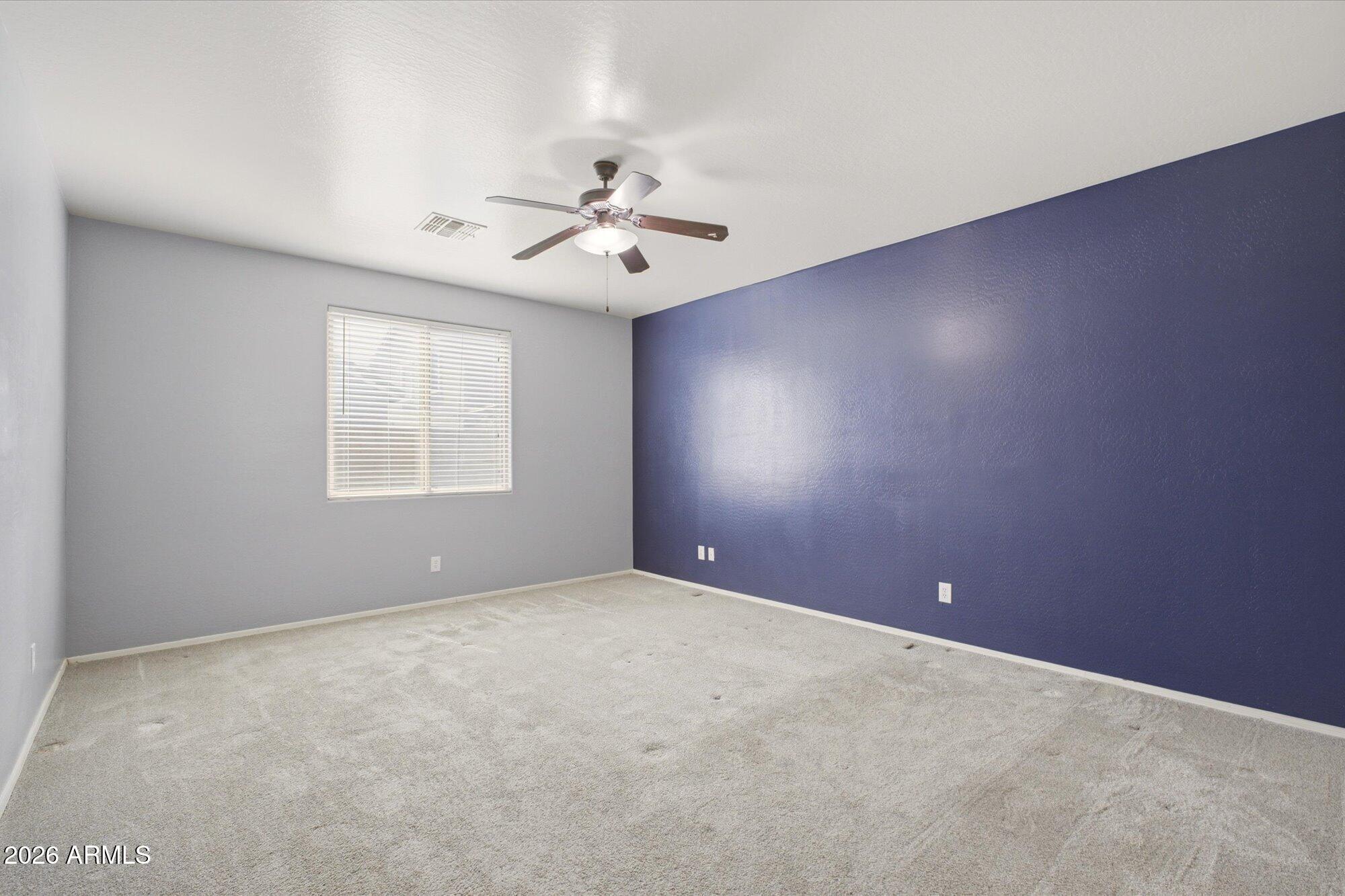 3347 East Roland Street Mesa, AZ 85213 - Photo 14 of 25 an empty room with windows and fan