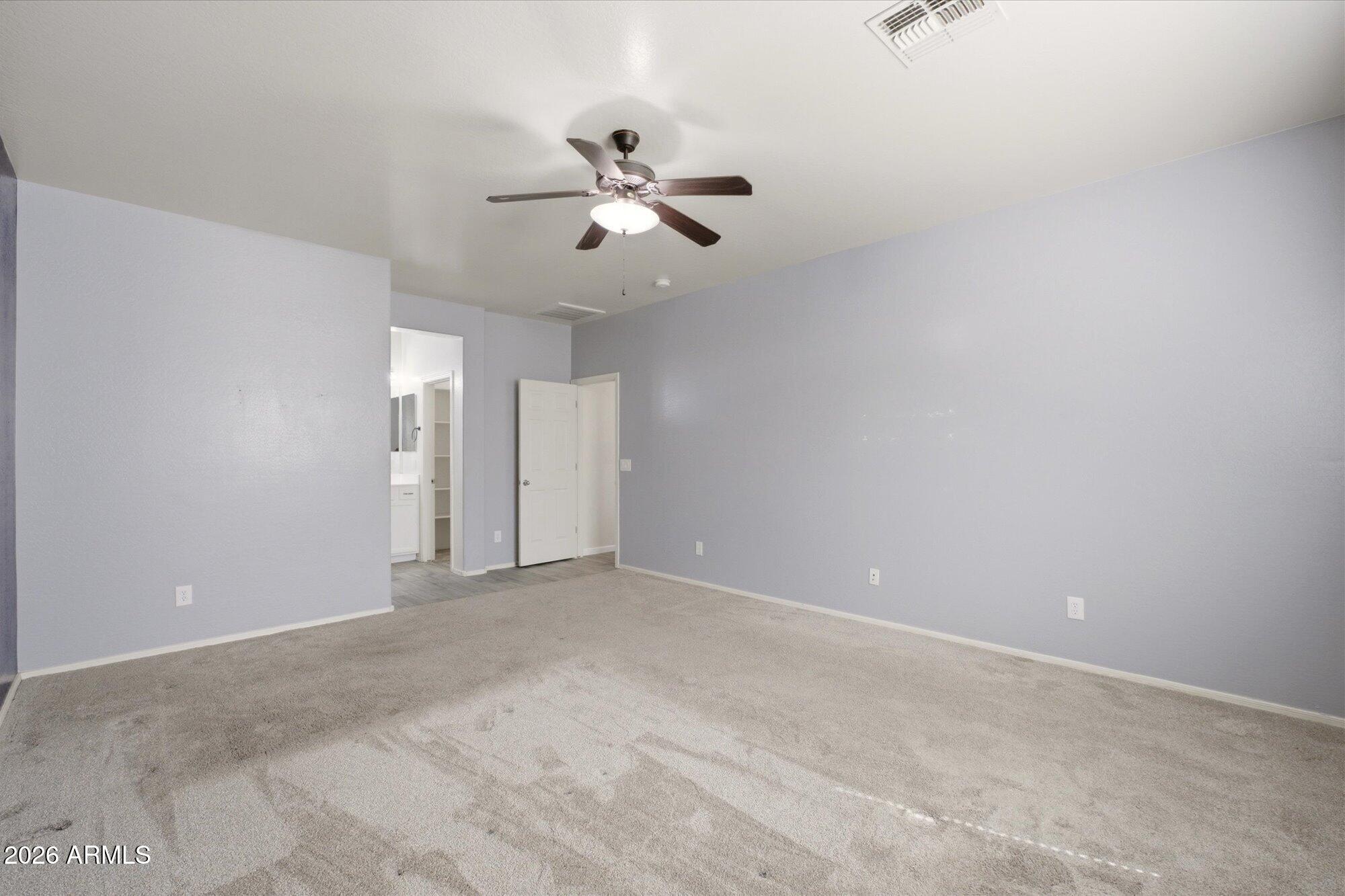 3347 East Roland Street Mesa, AZ 85213 - Photo 18 of 25 an empty room with windows and fan