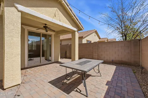 a view of a backyard with a patio and outdoor seating