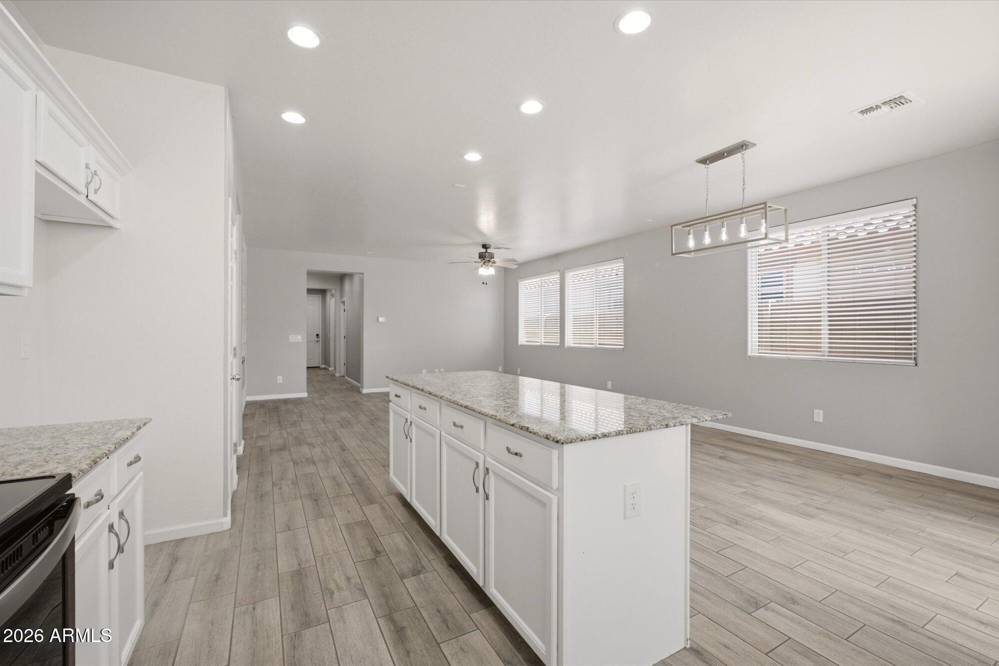 3347 East Roland Street Mesa, AZ 85213 - Photo 10 of 25 a view of a kitchen from the hallway with wooden floor