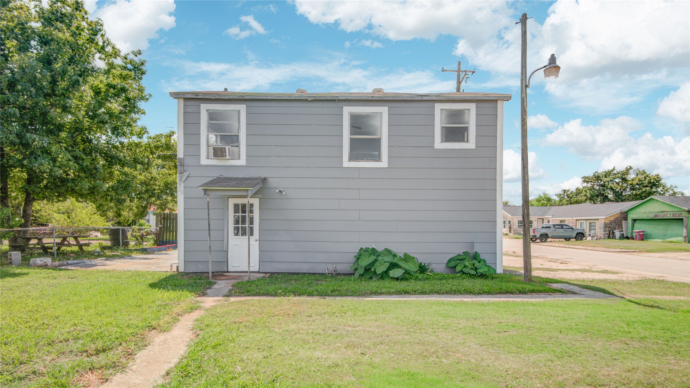 1131 West 2nd Street Freeport, TX 77541 - Photo 19 of 30 a brick house with a yard