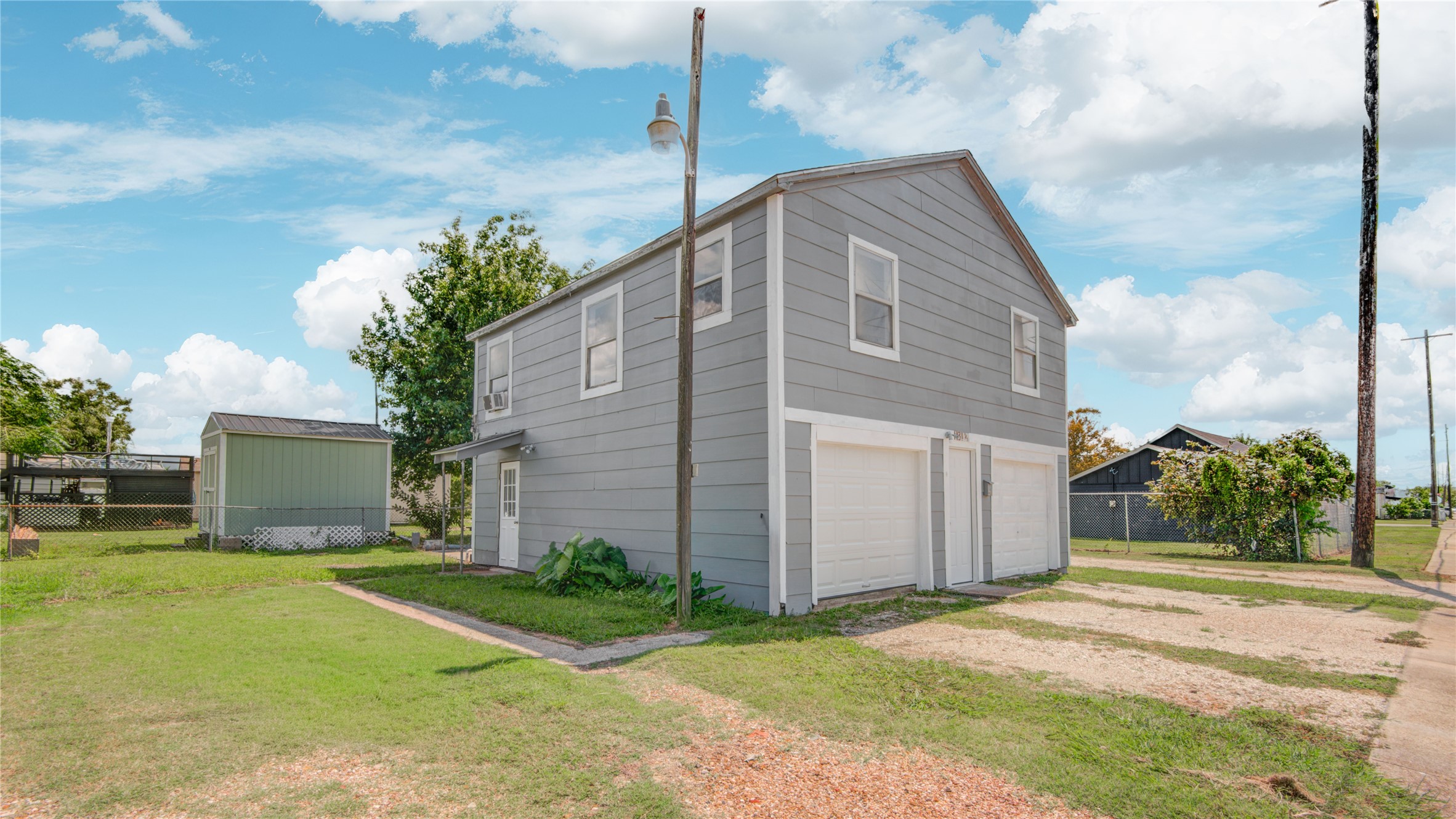 1131 West 2nd Street Freeport, TX 77541 - Photo 20 of 30 a backyard of a house with yard and garage