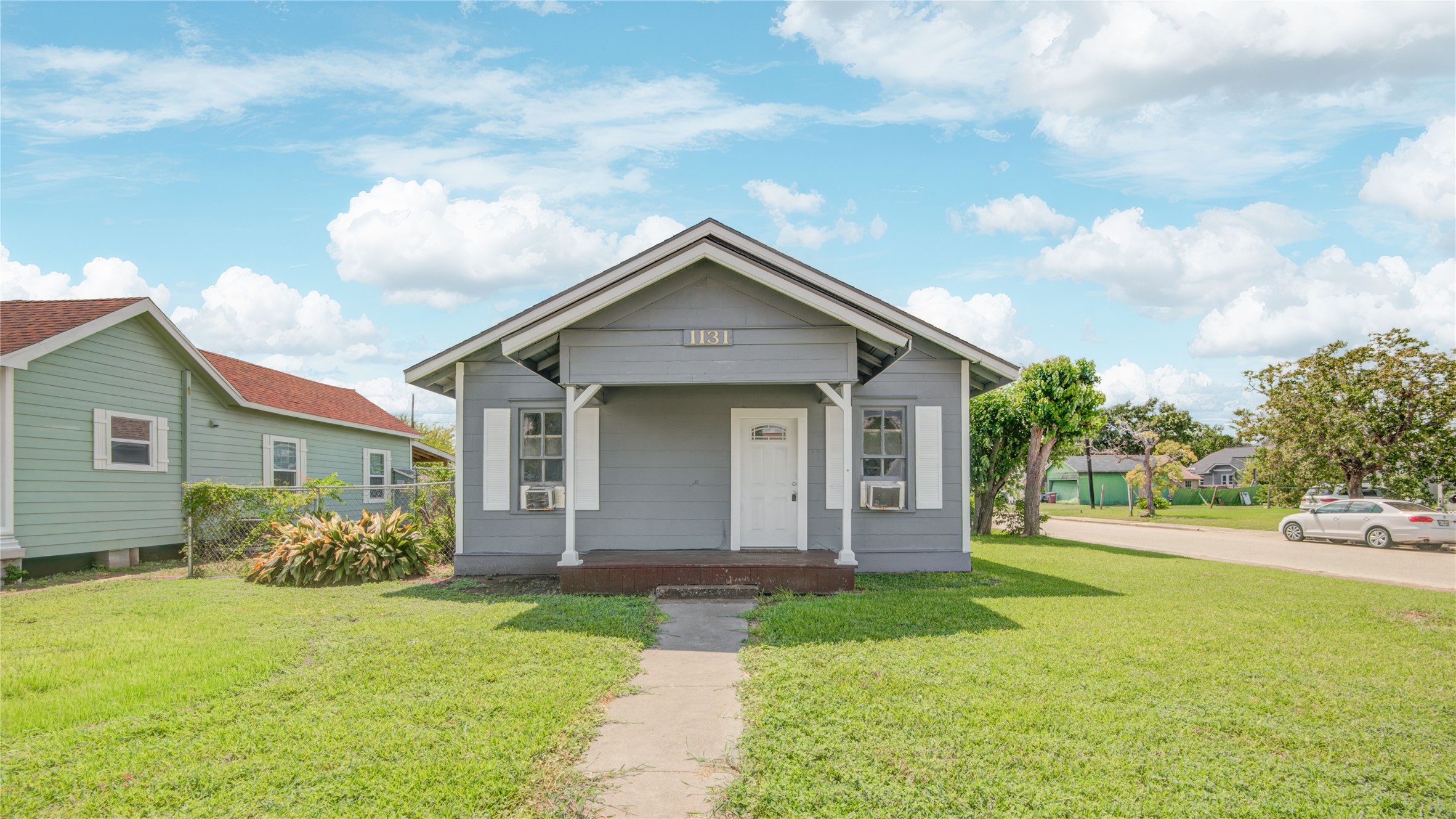 1131 West 2nd Street Freeport, TX 77541 - Photo 2 of 30 a front view of a house with garden
