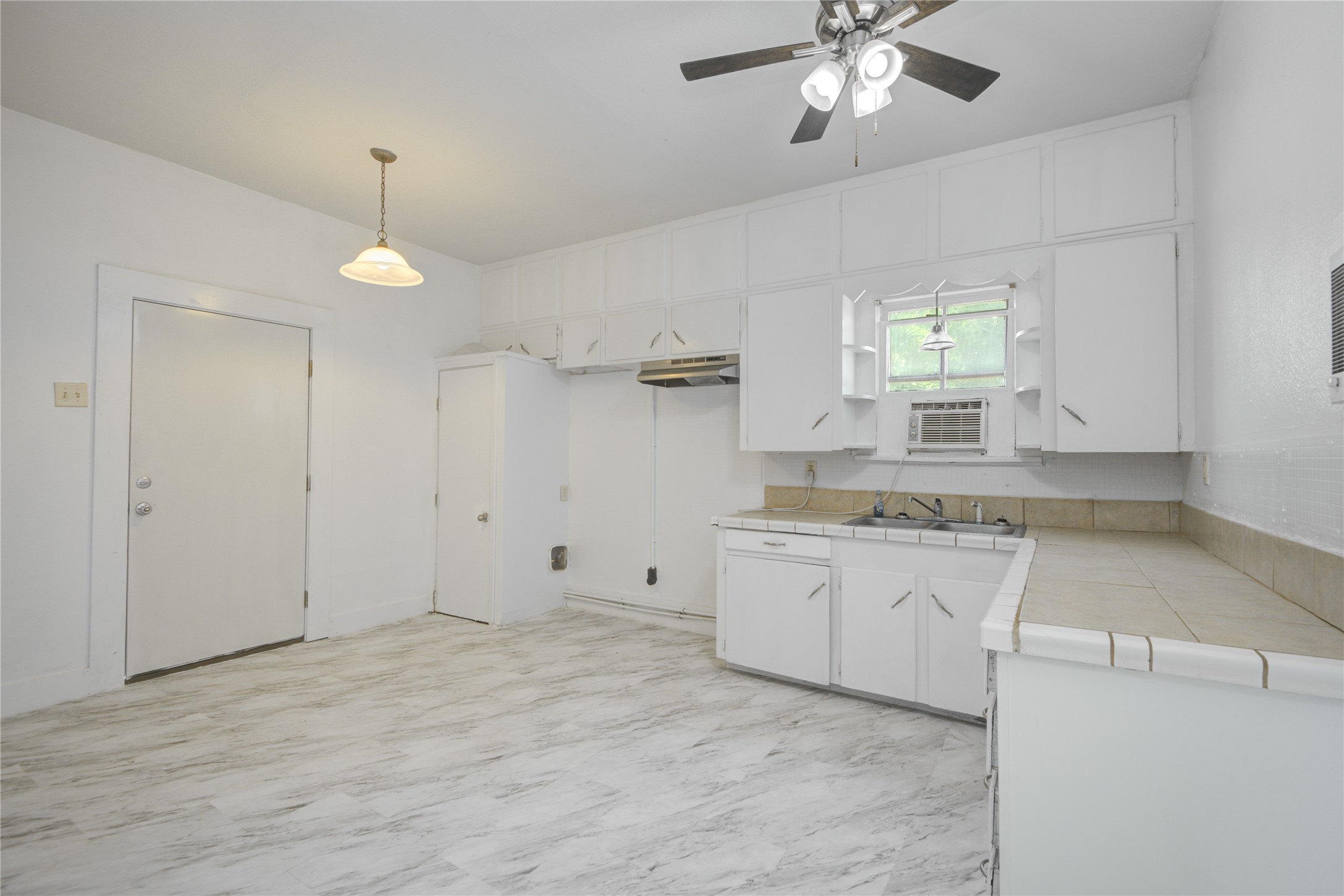 1131 West 2nd Street Freeport, TX 77541 - Photo 6 of 30 a view of a kitchen with a sink and dishwasher