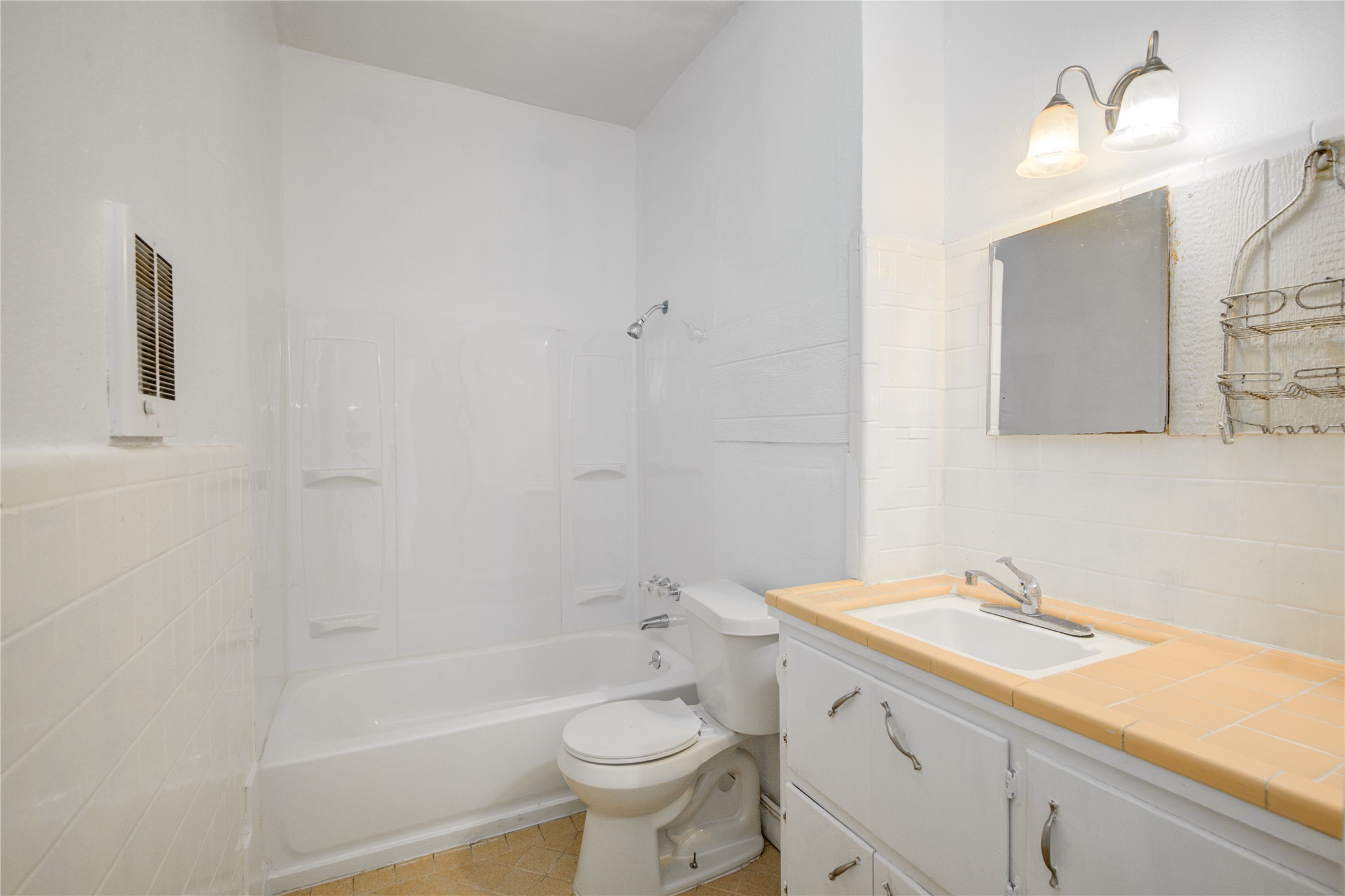 1131 West 2nd Street Freeport, TX 77541 - Photo 7 of 30 a bathroom with a sink a toilet and shower