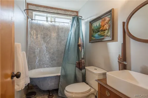 a bedroom with a bed a table and a window