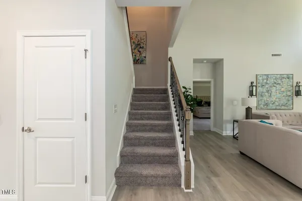 a view of a hallway with wooden floor and entryway