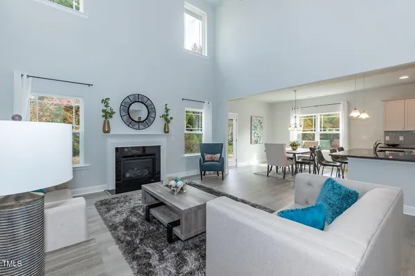 a living room with furniture a clock and a fireplace