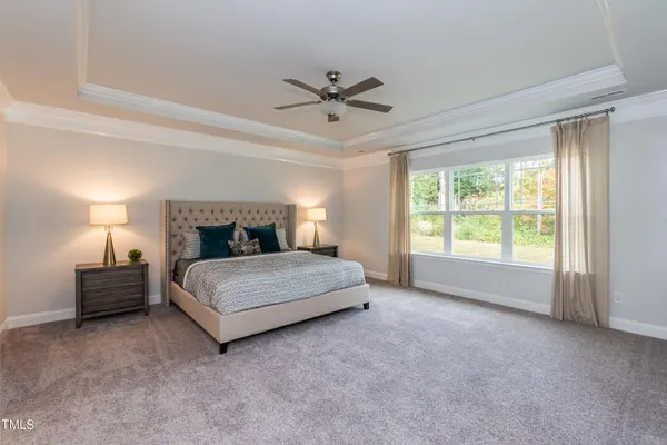 a spacious bedroom with a bed and window