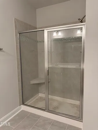 a bathroom with a glass shower door