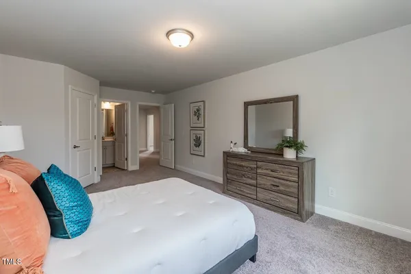 a bedroom with a bed and a mirror