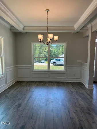 a view of a room wooden floor and windows