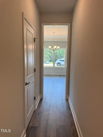 a view of hallway with wooden floor