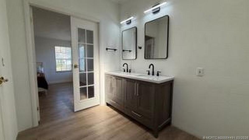 16537 Southwest Two Wood Way Indiantown, FL 34956 - Photo 11 of 14 a en suite bathroom with a sink and mirror