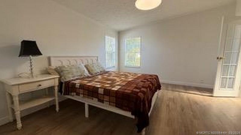 16537 Southwest Two Wood Way Indiantown, FL 34956 - Photo 2 of 14 a bedroom with a bed and a window
