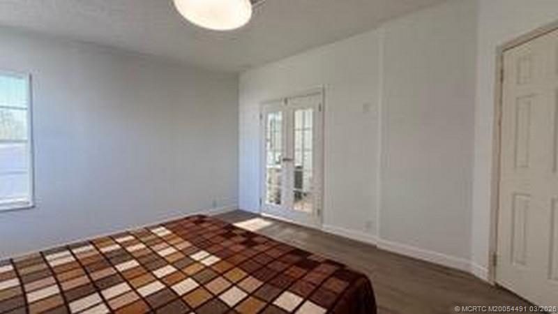 16537 Southwest Two Wood Way Indiantown, FL 34956 - Photo 3 of 14 a bedroom with a bed and a window