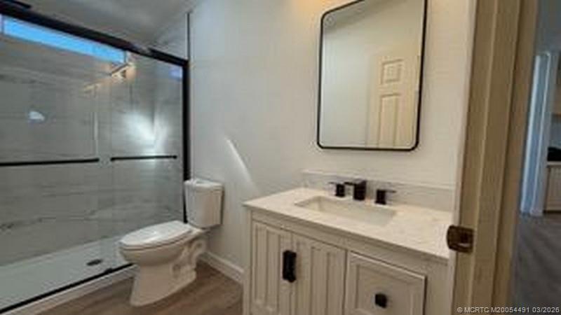 16537 Southwest Two Wood Way Indiantown, FL 34956 - Photo 5 of 14 a bathroom with a sink toilet and shower