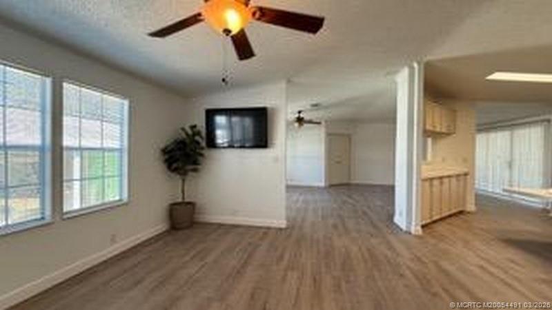 16537 Southwest Two Wood Way Indiantown, FL 34956 - Photo 6 of 14 a view of hallway with window and wooden floor