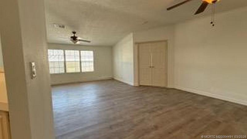 16537 Southwest Two Wood Way Indiantown, FL 34956 - Photo 8 of 14 an empty room with windows and closet