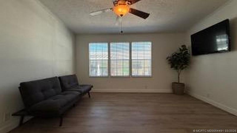 16537 Southwest Two Wood Way Indiantown, FL 34956 - Photo 9 of 14 a living room with furniture and a flat screen tv
