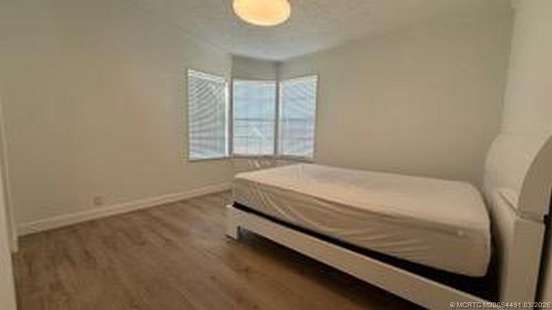 16537 Southwest Two Wood Way Indiantown, FL 34956 - Photo 10 of 14 a bed sitting in a bedroom next to a window