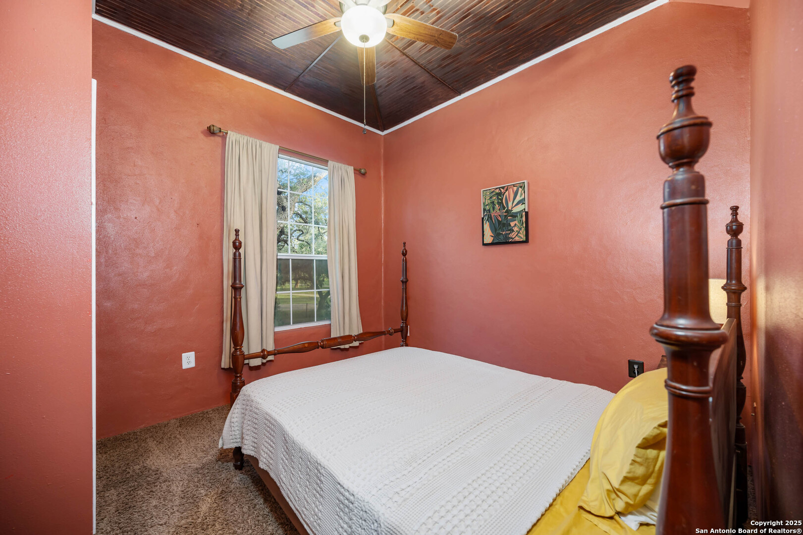 10655 Rebecca Creek Road Spring Branch, TX 78070 - Photo 17 of 34 a bed room with a bed and a chandelier