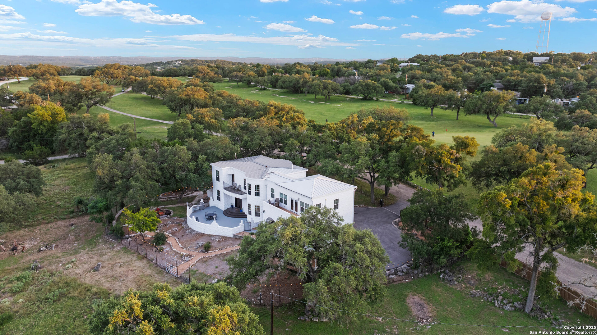 10655 Rebecca Creek Road Spring Branch, TX 78070 - Photo 2 of 34 an aerial view of a house with a yard