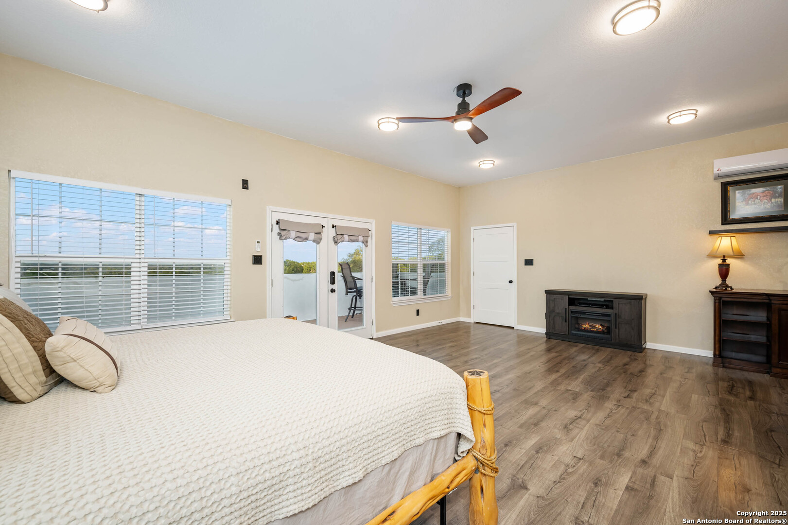 10655 Rebecca Creek Road Spring Branch, TX 78070 - Photo 22 of 34 a spacious bedroom with a bed and a view of kitchen