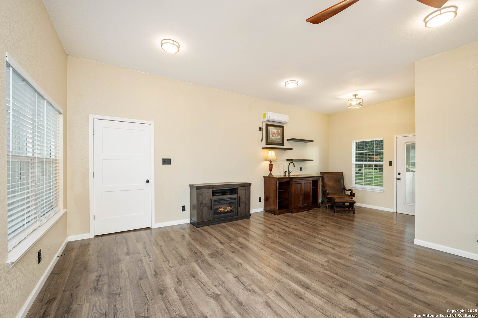 10655 Rebecca Creek Road Spring Branch, TX 78070 - Photo 23 of 34 an empty room with furniture and wooden floor