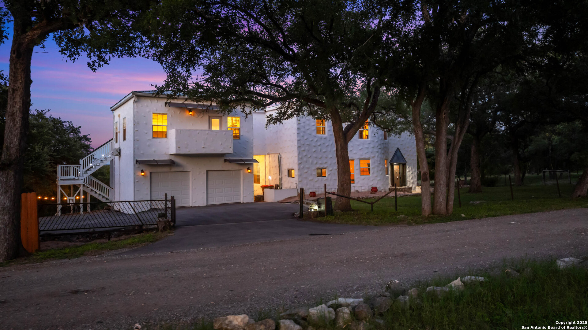 10655 Rebecca Creek Road Spring Branch, TX 78070 - Photo 4 of 34 a front view of a house with swing and plants